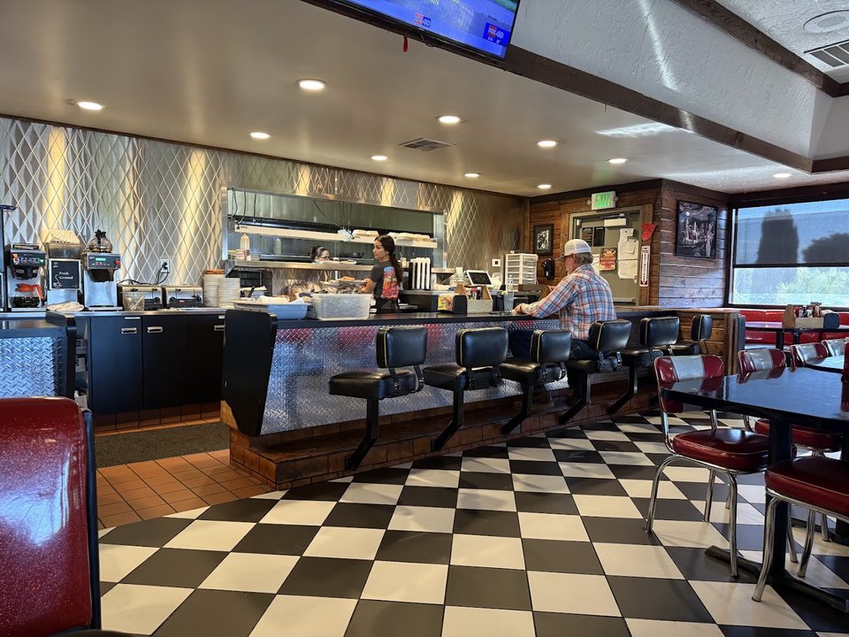 Retro diner booths with hot rod decor.